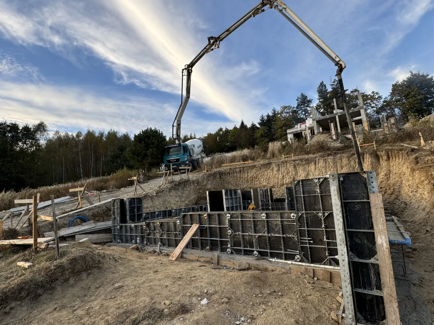 Betonowanie ścian fundamentowych pompą do betonu na pochyłej działce